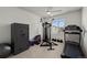 Home gym equipped with a treadmill, weight machine, and a secure Winchester safe at 730 Cottonwood Ave, Bennett, CO 80102