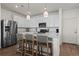 Modern kitchen featuring white cabinets, stainless steel appliances, and a large center island at 730 Cottonwood Ave, Bennett, CO 80102