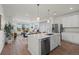 Open concept kitchen with a large island, stainless steel appliances, and modern finishes at 730 Cottonwood Ave, Bennett, CO 80102