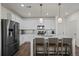 Modern kitchen featuring white cabinets, stainless steel appliances, and a large center island at 730 Cottonwood Ave, Bennett, CO 80102