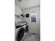 Efficient laundry room with modern washer and dryer, plus smart shelving at 730 Cottonwood Ave, Bennett, CO 80102