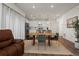 Open-concept living area with hardwood floors and seamless flow to the modern kitchen at 730 Cottonwood Ave, Bennett, CO 80102