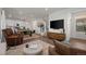 Open-concept living area with hardwood floors and seamless flow to the modern kitchen at 730 Cottonwood Ave, Bennett, CO 80102