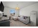 Cozy living area with a comfortable couch, bright window, and stylish decor at 730 Cottonwood Ave, Bennett, CO 80102