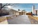 Single-Gathering home featuring a large driveway, 2-car garage, and a covered front porch at 10078 Telluride St, Littleton, CO 80125