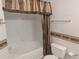Standard bathroom features a bathtub and shower combination with neutral decor at 7369 S Alkire St # 203, Littleton, CO 80127