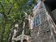 Low angle view of stone exterior of home and tree with branches in the foreground at 7369 S Alkire St # 203, Littleton, CO 80127
