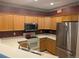 Well-equipped kitchen with modern appliances and wood cabinetry and contrasting backsplash at 7369 S Alkire St # 203, Littleton, CO 80127