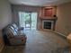 Comfortable living room featuring fireplace, and sliding doors opening onto a balcony at 7369 S Alkire St # 203, Littleton, CO 80127