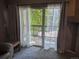 Bright living room with balcony entrance and view of trees outside at 7369 S Alkire St # 203, Littleton, CO 80127