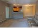 Spacious living area with fireplace, leather sofa and kitchen space at 7369 S Alkire St # 203, Littleton, CO 80127