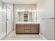 A modern bathroom featuring double sinks, and a glass-enclosed shower, creating a spa-like experience at 21022 E 63 Dr, Aurora, CO 80019
