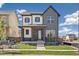 Attractive two-story home featuring a stone facade, covered porch, and well-maintained lawn at 21022 E 63 Dr, Aurora, CO 80019