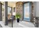 Welcoming front porch with comfortable seating and stylish accents, next to a modern front door at 21022 E 63 Dr, Aurora, CO 80019