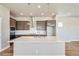 Contemporary kitchen features a center island with quartz countertop, stainless steel appliances, and ample cabinet space at 21022 E 63 Dr, Aurora, CO 80019