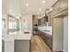 Contemporary kitchen design with a large island, stainless steel appliances, and hardwood flooring at 21022 E 63 Dr, Aurora, CO 80019