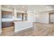 Bright and airy kitchen showcasing a large island, modern cabinetry, recessed lighting, and hardwood floors at 21022 E 63 Dr, Aurora, CO 80019
