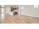 Open living space showcasing hardwood floors connecting the living area to the kitchen, great for modern living at 21022 E 63 Dr, Aurora, CO 80019