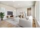 Bright living room with modern furniture, a large window, and stylish decor accents at 21022 E 63 Dr, Aurora, CO 80019