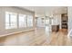 Expansive living space with large windows showcasing community view, seamlessly connecting to modern kitchen at 21022 E 63 Dr, Aurora, CO 80019