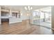 Spacious living room featuring hardwood floors, an open concept kitchen, and natural light through large sliding doors at 21022 E 63 Dr, Aurora, CO 80019