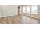 Inviting living room featuring wood flooring, ample natural light, and a modern design, great for entertaining at 21022 E 63 Dr, Aurora, CO 80019