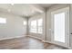 Bright living room featuring wood flooring, modern windows, and a neutral color palette for versatile styling at 21022 E 63 Dr, Aurora, CO 80019