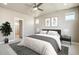 Serene main bedroom with soft lighting, ceiling fan, and neutral decor creating a peaceful retreat at 21022 E 63 Dr, Aurora, CO 80019