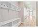 Mud room with built-in shelving, hooks, a bench, and easy access to entryways, perfect for organization at 21022 E 63 Dr, Aurora, CO 80019