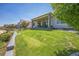 Well-maintained backyard with a lush lawn and a covered patio, offering a serene outdoor space at 20553 E 50Th Pl, Denver, CO 80249