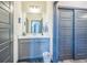 Well-lit bathroom with cabinet storage and sliding closet doors, offering convenience at 20553 E 50Th Pl, Denver, CO 80249