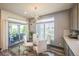 Dining area with a sliding glass door, modern lighting, and neutral tones, ideal for entertaining guests at 20553 E 50Th Pl, Denver, CO 80249