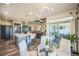 Dining area with modern table, stylish chairs, a sliding glass door, and seamless flow into the kitchen at 20553 E 50Th Pl, Denver, CO 80249