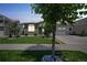 Inviting home with stone accents, a manicured lawn, and a well-maintained landscape at 20553 E 50Th Pl, Denver, CO 80249