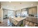 Spacious kitchen features a large island, stainless steel appliances, modern lighting, and stylish finishes at 20553 E 50Th Pl, Denver, CO 80249