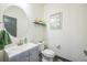 Small powder room features a round mirror and a shelf for decor at 20553 E 50Th Pl, Denver, CO 80249