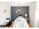 A cozy bedroom features charming decor, hardwood floors, and a calming color palette at 16012 E Floyd Ave, Aurora, CO 80013