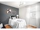This bedroom features wood floors, a window, a bed and unique ceiling lights at 16012 E Floyd Ave, Aurora, CO 80013