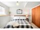 Finished basement bedroom with a comfortable bed, window and simple furnishings at 16012 E Floyd Ave, Aurora, CO 80013