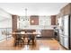 A charming kitchen featuring a stainless steel refrigerator, and a wooden table with seating at 16012 E Floyd Ave, Aurora, CO 80013