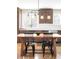 A kitchen featuring a wooden dining table with a view through the windows at 16012 E Floyd Ave, Aurora, CO 80013