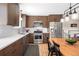 A modern kitchen with stainless steel appliances and brown cabinets for ample storage space at 16012 E Floyd Ave, Aurora, CO 80013