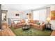 A living room with brown sectional sofa, green rug, and coffee sack wall decor at 16012 E Floyd Ave, Aurora, CO 80013