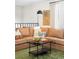 A cozy living room with a brown sectional sofa, a green patterned rug and decorations at 16012 E Floyd Ave, Aurora, CO 80013