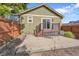 Back exterior featuring a patio area, sliding glass doors, and a private fenced-in yard at 4825 S Ammons St # 133, Littleton, CO 80123