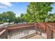 Cozy backyard featuring a small patio with a metal table, surrounded by a wood fence at 4825 S Ammons St # 133, Littleton, CO 80123