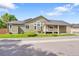 Charming home featuring an inviting front porch, manicured lawn, and appealing architectural details at 4825 S Ammons St # 133, Littleton, CO 80123