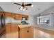 The kitchen has granite countertops, an island, wood cabinets, and modern black appliances at 4825 S Ammons St # 133, Littleton, CO 80123