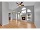 Bright living room with fireplace, high ceilings, and large windows, showcasing an airy atmosphere at 4825 S Ammons St # 133, Littleton, CO 80123