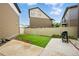 Backyard featuring a concrete patio and low-maintenance artificial turf at 18619 E 50Th Pl, Denver, CO 80249
